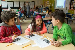 Two fourth-grade boys and a fourth-grade girl working together